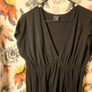 A black low V neck dress.